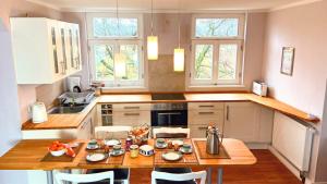 a kitchen with a wooden table and a counter top at Ferienwohnung Schmilau in Schmilau +14 photos