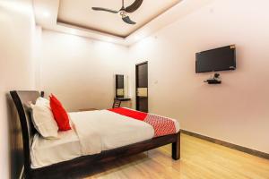 a bedroom with a bed and a flat screen tv at Vaibhav Laxmi Paradise in Chinhat