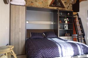 a bedroom with a bed with purple sheets and a ladder at Le cerisier de Mamie in Bagnères-de-Bigorre