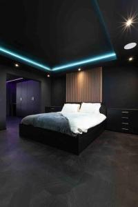 a bedroom with a bed with a blue light at Luxury Couples Get-Away Glasgow in Knightswood