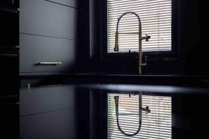 a kitchen sink with a faucet in front of a window at Luxury Couples Get-Away Glasgow in Knightswood