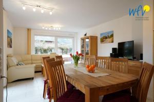 - un salon avec une table en bois et un canapé dans l'établissement Villa Schoen 58091, à Borkum