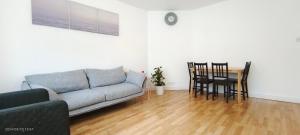 a living room with a couch and a table at Maple House near Wembley Stadium in London