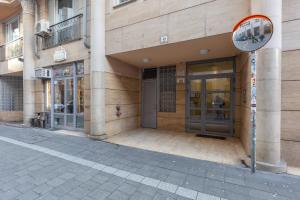 an entrance to a building with a sign in front of it at Downtown Nature Apartment in Budapest