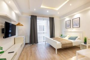 a bedroom with a bed and a large window at Downtown Nature Apartment in Budapest