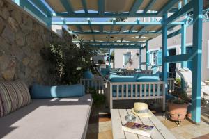 a patio with a couch and a table at Villa Rose in Fira