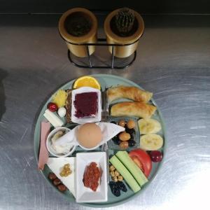 a plate of breakfast foods on a table at Hikmethan Otel in Kusadası