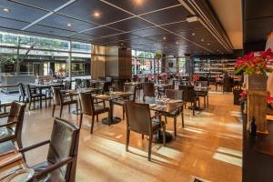 a restaurant with tables and chairs in a room at Hilton Buenos Aires in Buenos Aires