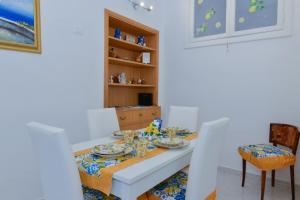 a dining room with a table and chairs at Casa Natalia in Sorrento