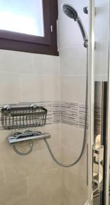 a shower in a bathroom with a glass door at Superbe T2 climatisé, proche plage avec parking privé in Saint-Cyprien +15 photos