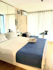a large bed in a room with a large window at ORBI CITY sea in Batumi