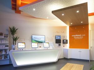 a pharmacy with a white counter in a room at easyHotel Amsterdam Arena Boulevard in Amsterdam