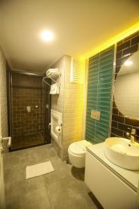 a bathroom with a toilet and a sink and a shower at ÇEVİK PALACE HOTEL in Antalya