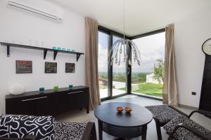 a living room with a table and a large window at Modern Villa Anna with outdoor pool in Visnjan in Višnjan
