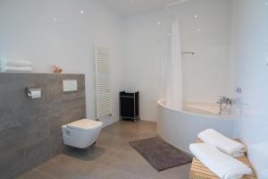 a bathroom with a tub and a toilet and a sink at Modern Villa Anna with outdoor pool in Visnjan in Višnjan +24 photos