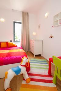 a bedroom with a bed with a toy horse on the floor at Modern Villa Anna with outdoor pool in Visnjan in Višnjan