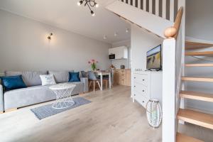 a living room with a couch and a table at Apartamenty Lagos in Karwia