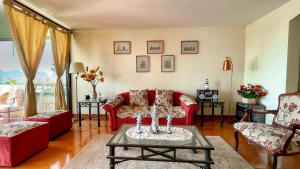 una sala de estar con sofás rojos y una mesa. en Departamentos Heimat 4 en La Serena