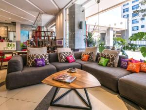a living room with couches and a coffee table at ibis Styles - Nairobi, Westlands in Nairobi