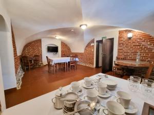 a table with cups and saucers on top of it at Muzeum Ziemiaństwa w Dąbrowie in Przesmyki