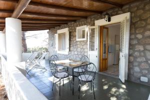 a patio with a table and chairs on a house at Case Vacanze Margherita in Lipari