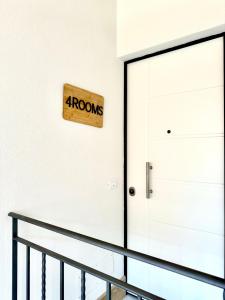 a door with a arrow sign on the wall at 4Rooms in Palermo