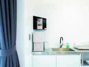 a kitchen with a sink and a counter top at Boutique Pool Villa NAMIB in Jeju