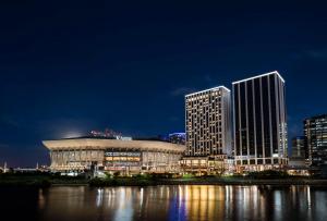 a large building in a city at night at Hilton Yokohama in Yokohama