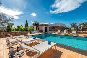 a villa with a swimming pool and a house at Can White in Sant Carles de Peralta