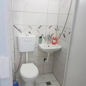 a bathroom with a toilet and a sink at New Studio in Pogradec