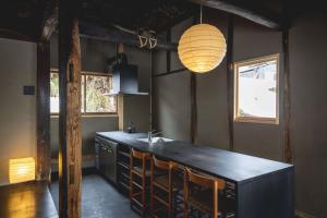 a kitchen with a black counter and a sink at awai 戸隠 in Nagano