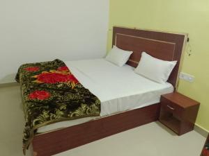 a bedroom with a large bed with at YESH PALACE HOMESTAY in Khajurāho