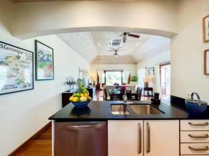 a kitchen with a sink and a bowl of fruit on the counter at The Hideaway Suite 1512 Pool and Sea views in Gaynors