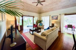 a living room with a couch and a table at The Hideaway Suite 1512 Pool and Sea views in Gaynors