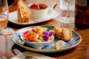 a table with a bowl of food on a plate at The Glengower in Aberystwyth