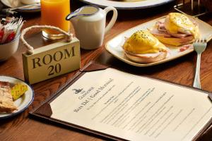 a table with two plates of food and a menu at The Glengower in Aberystwyth