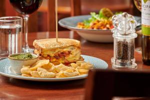 a sandwich and chips on a plate on a table at The Glengower in Aberystwyth