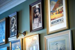 a bunch of pictures hanging on a wall at The Glengower in Aberystwyth
