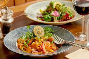 a table with two plates of food and a salad at The Glengower in Aberystwyth