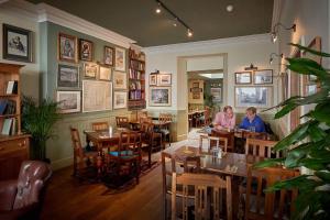 two women sitting at tables in a restaurant at The Glengower in Aberystwyth