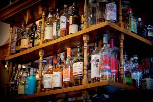 a bunch of bottles of alcohol sitting on shelves at The Glengower in Aberystwyth