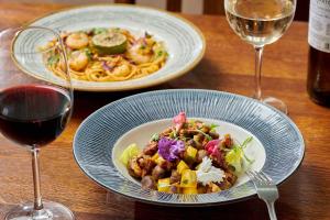 two plates of food on a table with wine glasses at The Glengower in Aberystwyth