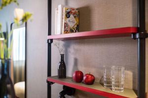 a shelf with two apples and a bottle and glasses at me and all hotel Berlin east side, part of JdV by Hyatt in Berlin