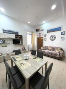a living room with a dining table and a couch at Ginevra’s Apartment in Naples +62 photos