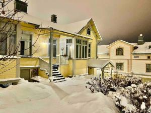 a house with snow on the ground in front of it at 19th century house with parking hall, own entrance and terrace in Vaasa