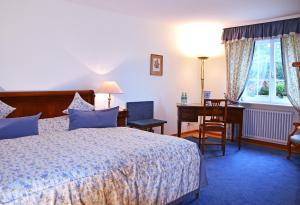 Postel nebo postele na pokoji v ubytování Hotel Mühle