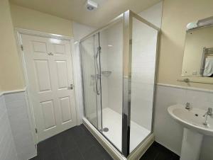 a bathroom with a shower and a sink at The Glengower in Aberystwyth