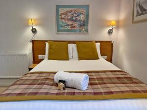 a bedroom with a bed with a towel on it at The Glengower in Aberystwyth