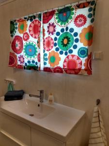 a bathroom with a sink and a window with flowers at 1940s house in Vestre Toten in Boverbru