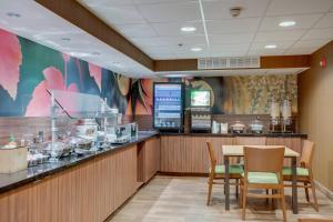 a restaurant with a bar with chairs and a table at Fairfield Inn by Marriott Amesbury in Amesbury